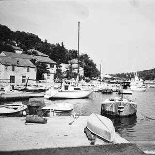 Marina with boats docked near coastal buildings.