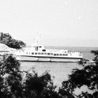 Ferry docked at seaside passenger terminal.