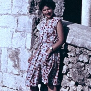 Ruined stone staircase with woman standing.