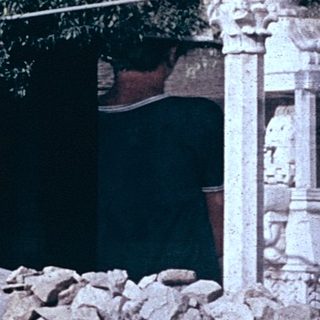 Ruined stone staircase with woman standing.