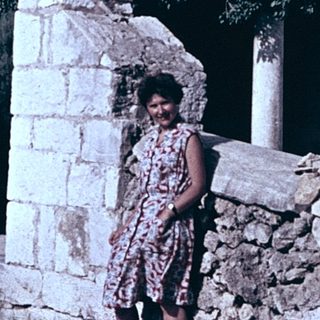 Ruined stone staircase with woman standing.