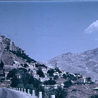 Rural hillside village with winding road.