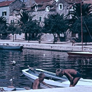 Historic coastal town with boats and old stone buildings.