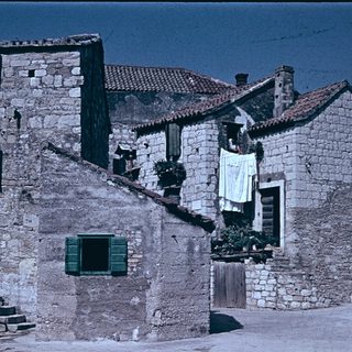 Rural stone houses with laundry drying.