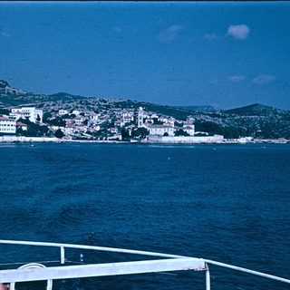 Coastal town nestled by deep blue sea.