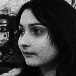 Woman posing beside abstract expressionist painting.