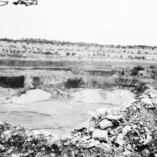 Open-pit mining excavation with exposed rock.