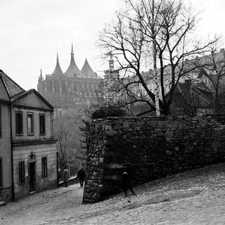 Historic European town with medieval castle ruins.