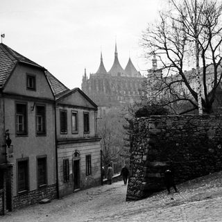 Historic European town with medieval castle ruins.
