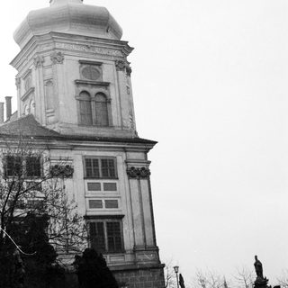 Historic building with clock tower and statues.