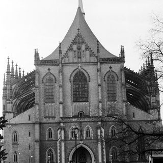 Gothic-style cathedral with pointed arches and vintage cars.