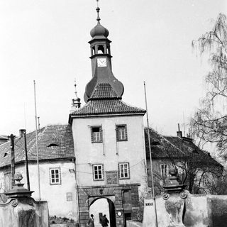 Historic town gate with clock tower and archway.