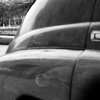 Close-up of scratched car door.