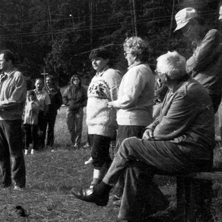 Group of people gathered outdoors for a public event or speech.