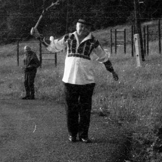 People playing frisbee in rural outdoor setting.