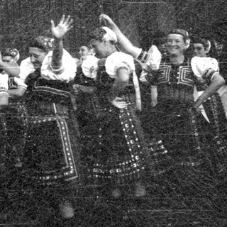 Traditional folk dance performance in colorful costumes.