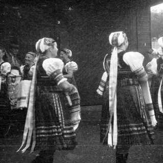 Traditional folk dancers in ornate costumes performing.