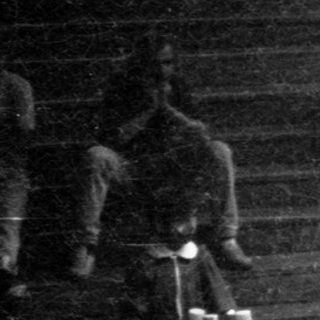 People gathered on wide stairs during an outdoor event.
