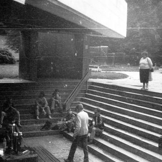 People gathered on wide stairs during an outdoor event.