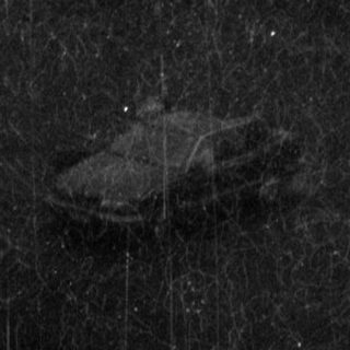 Rain-soaked rural landscape with military tank.