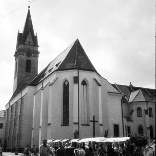 Historic church with steep spire and pointed arches.