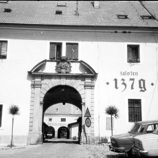 Historic gate marked "Založen 1379" with archway.