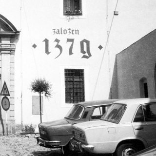 Historic gate marked "Založen 1379" with archway.