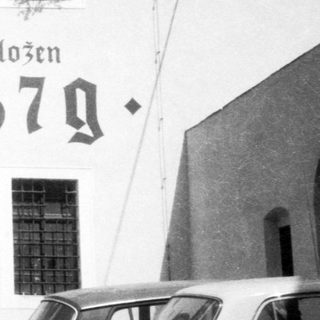 Historic gate marked "Založen 1379" with archway.