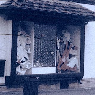Vintage street view of small-town shops and buildings.
