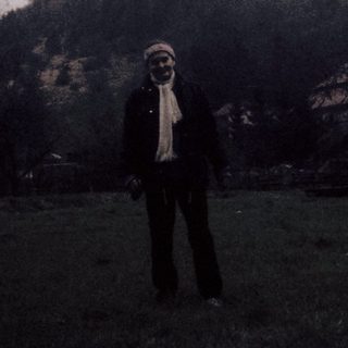 Person standing in front of castle hill.