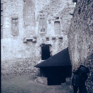 Medieval stone castle courtyard with old architecture.