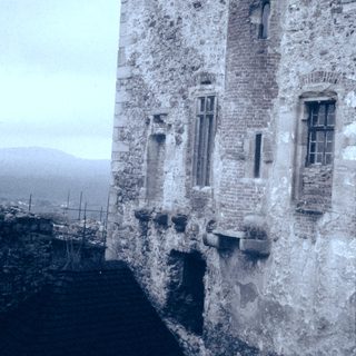 Medieval stone tower with weathered walls.