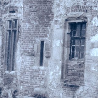 Medieval stone tower with weathered walls.