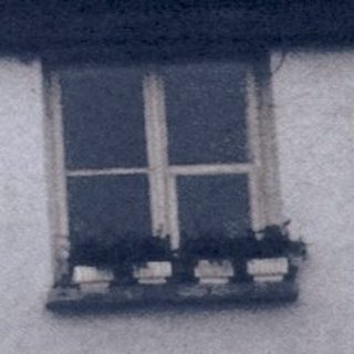 Rural houses with sloped roofs, bare trees.