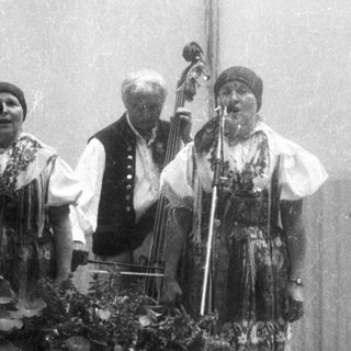 Traditional folk musicians performing with instruments.