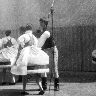 Traditional folk dancers performing on stage.