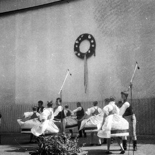 Traditional folk dancers performing on stage.
