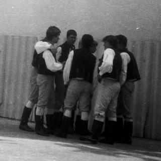 Group performing traditional folk dance with hand-holding.