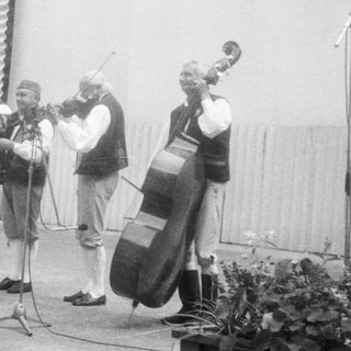 Street band performing traditional folk music outdoors.