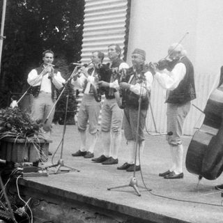 Street band performing traditional folk music outdoors.