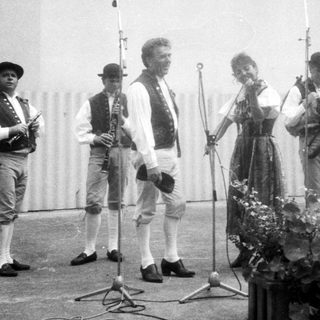 Traditional folk musicians performing outdoors.