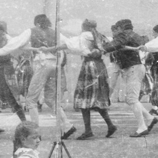 Children participating in a traditional rope-pulling game outdoors.