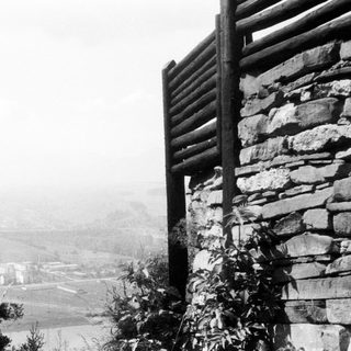 Rustic stone wall overlooking misty valley.