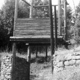 Traditional wooden observation tower with stone base.