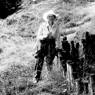 Person in outdoor setting with vintage camera equipment.