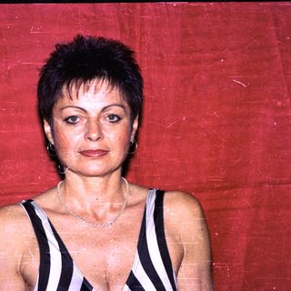 Woman in black-and-white striped top posing.