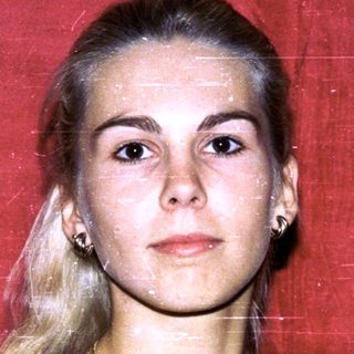 Young woman with blonde hair in black dress.
