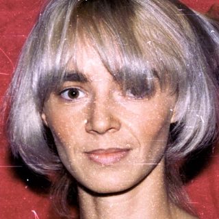 Woman with short blonde hair in striped top.