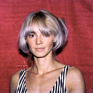Woman with short blonde hair in striped top.