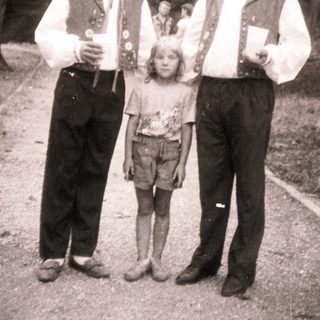 Family portrait in traditional attire outdoors.